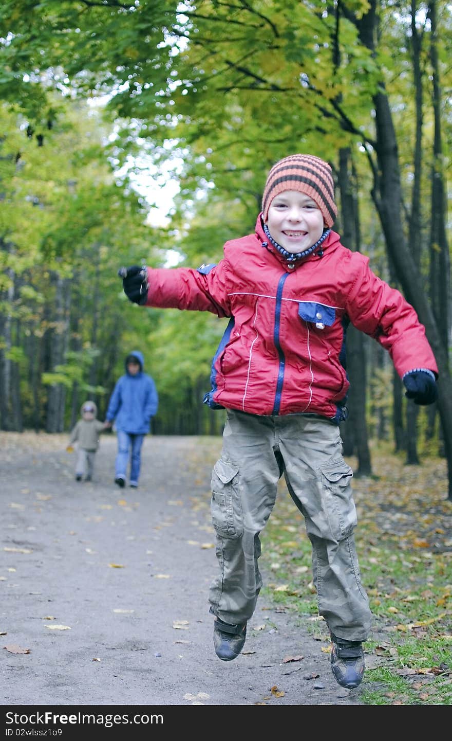 Boy jumping in autumn park