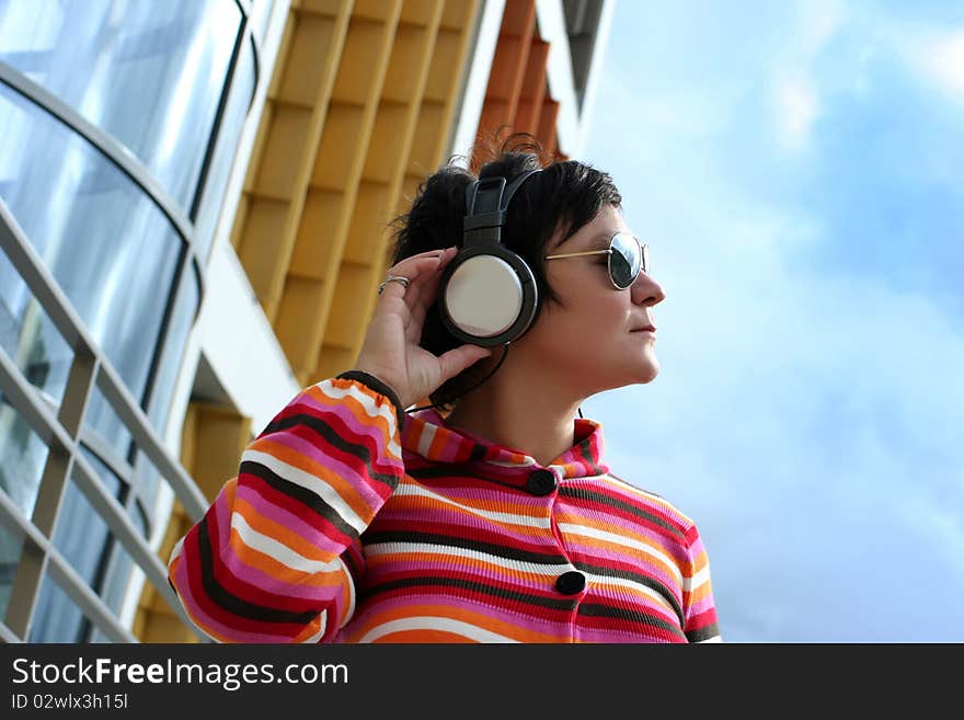 Attractive woman enjoying music outdoors