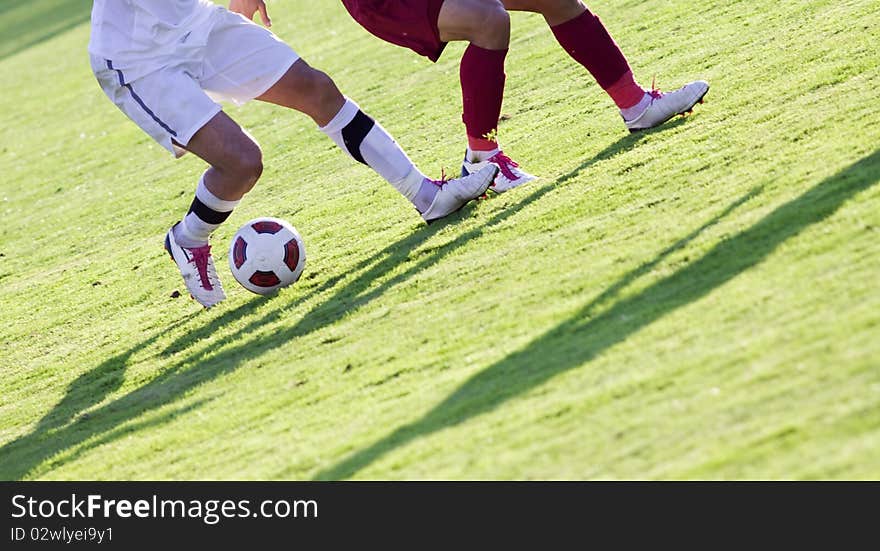 Soccer players running after the ball