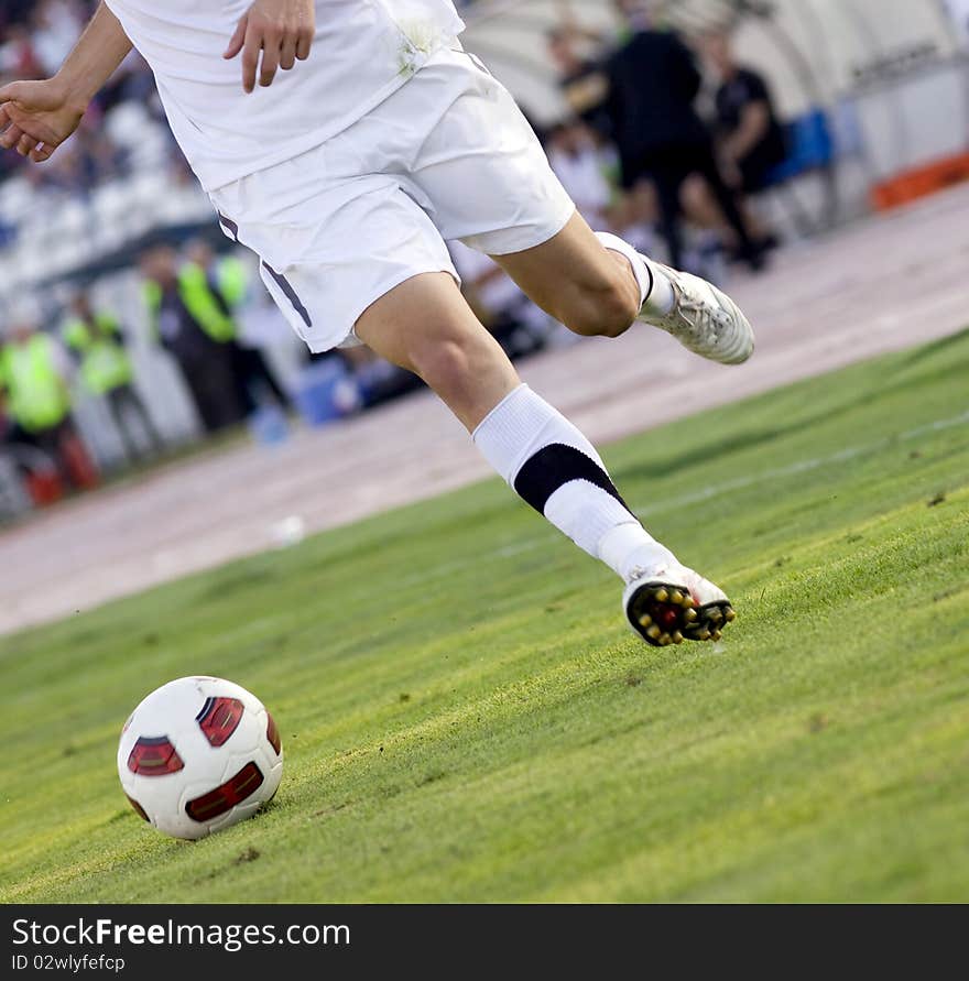 Soccer player running after the ball