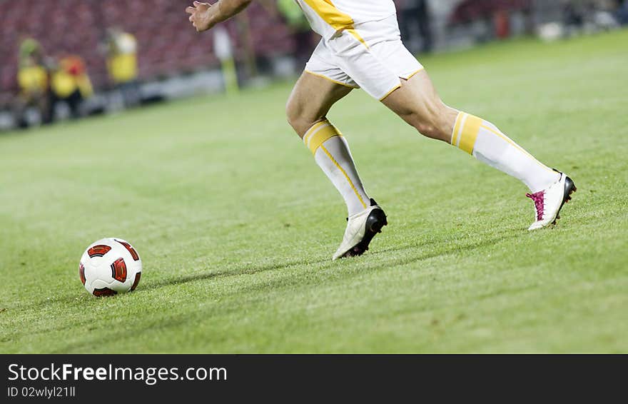 Soccer player running after the ball