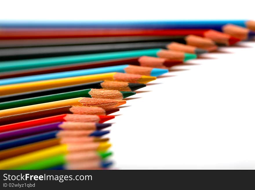 Colored pencils forming a line with a white background. Colored pencils forming a line with a white background