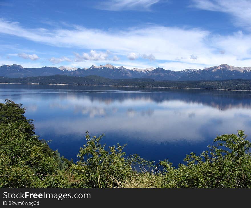 A beautiful mountain skyline mirrored on a lake. A beautiful mountain skyline mirrored on a lake