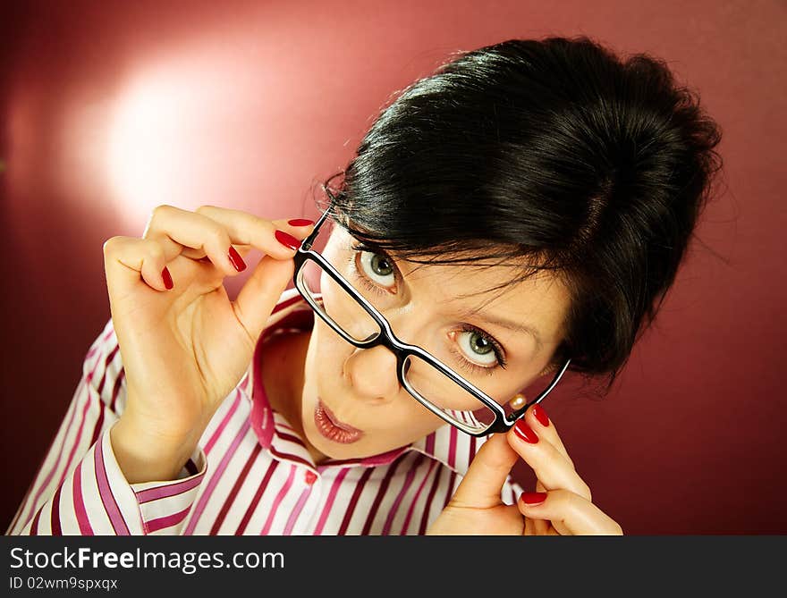 Nerdy office woman over bordeaux background looking ecstatic. Nerdy office woman over bordeaux background looking ecstatic