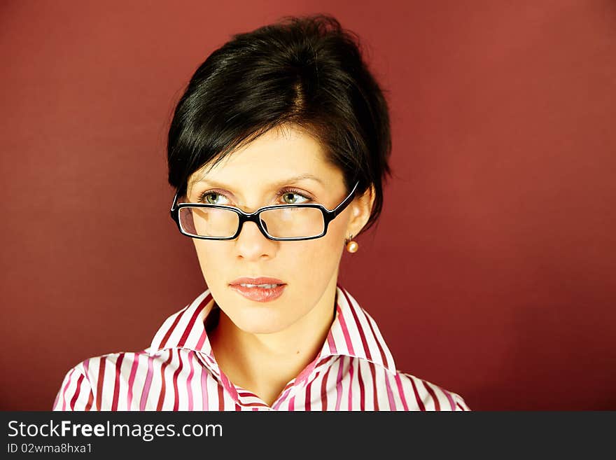 Nerdy office woman over bordeaux background looking ecstatic. Nerdy office woman over bordeaux background looking ecstatic