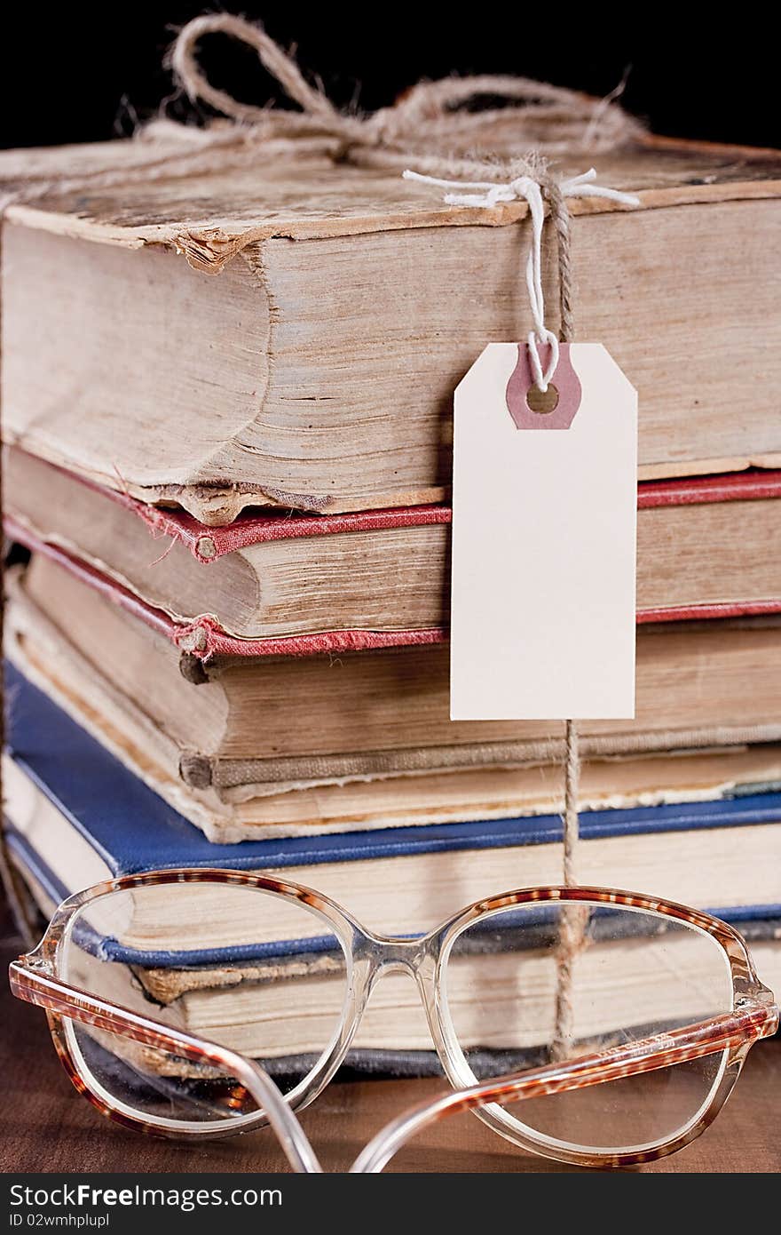 Antiquarian books in a library book-depository are combined by a pile. Antiquarian books in a library book-depository are combined by a pile.