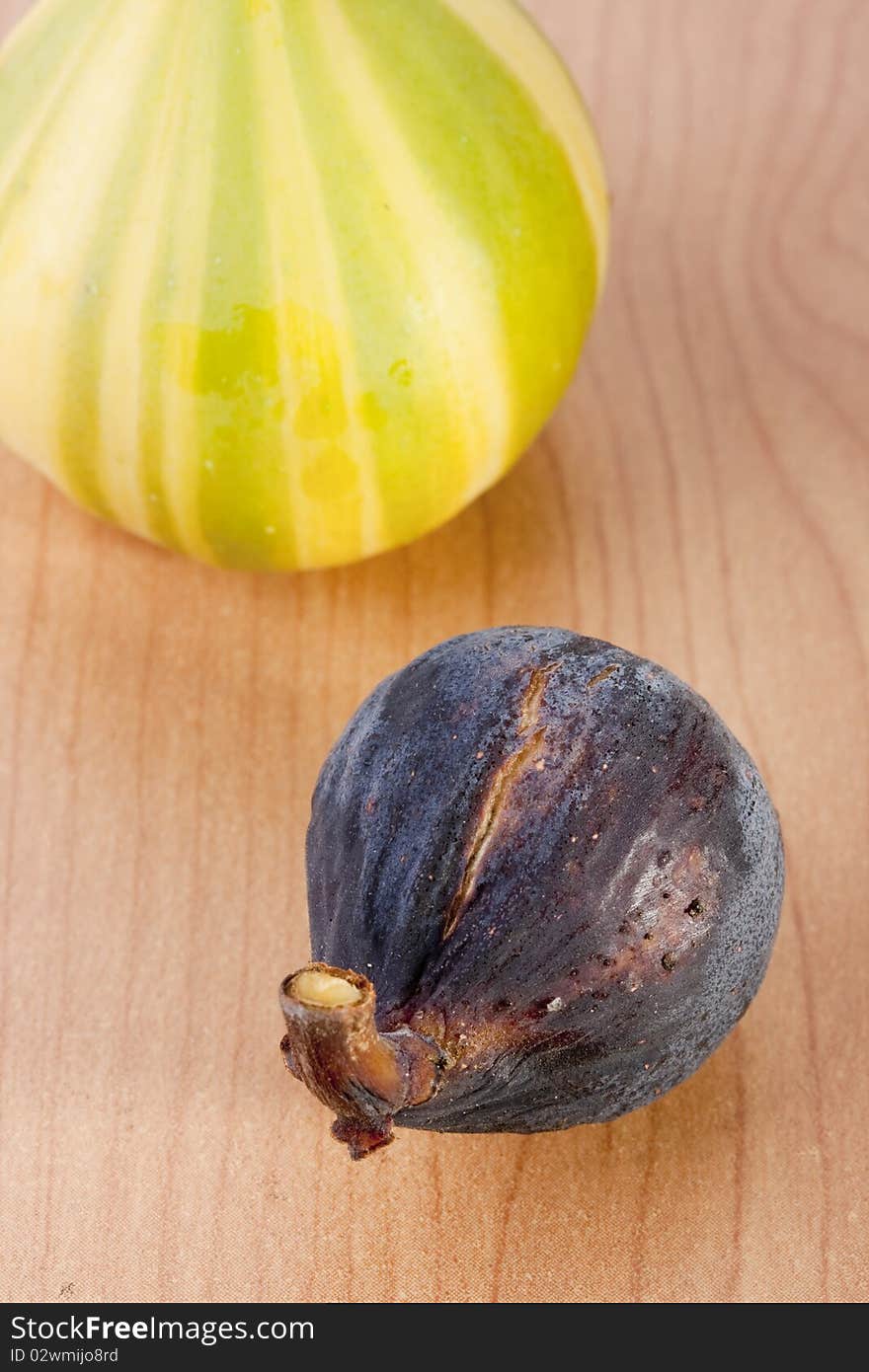 Ripe fruits of a fig on a wooden table.