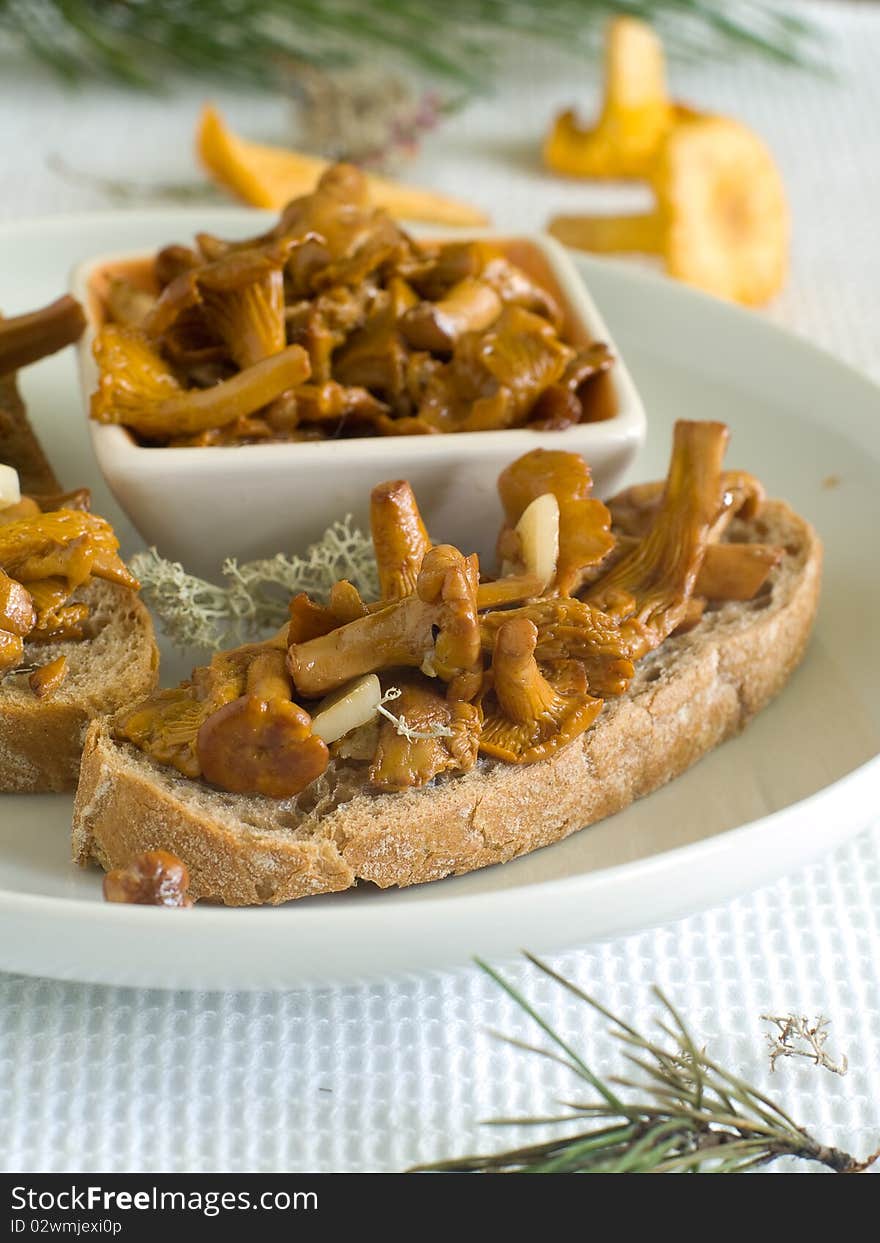 Bread with chanterelles on plate for appetizer