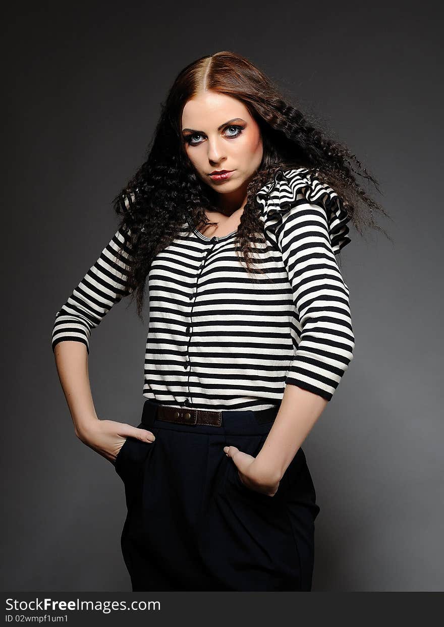 Beautiful fashion woman in stripy top with creative make-up posing. Beautiful fashion woman in stripy top with creative make-up posing