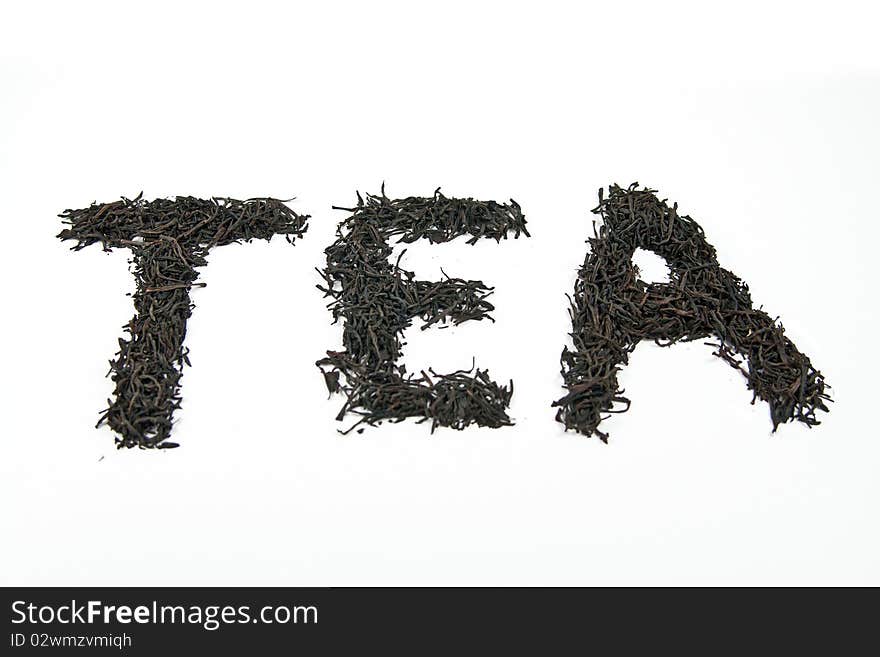 Word tea made of dry leaves isolated on white back