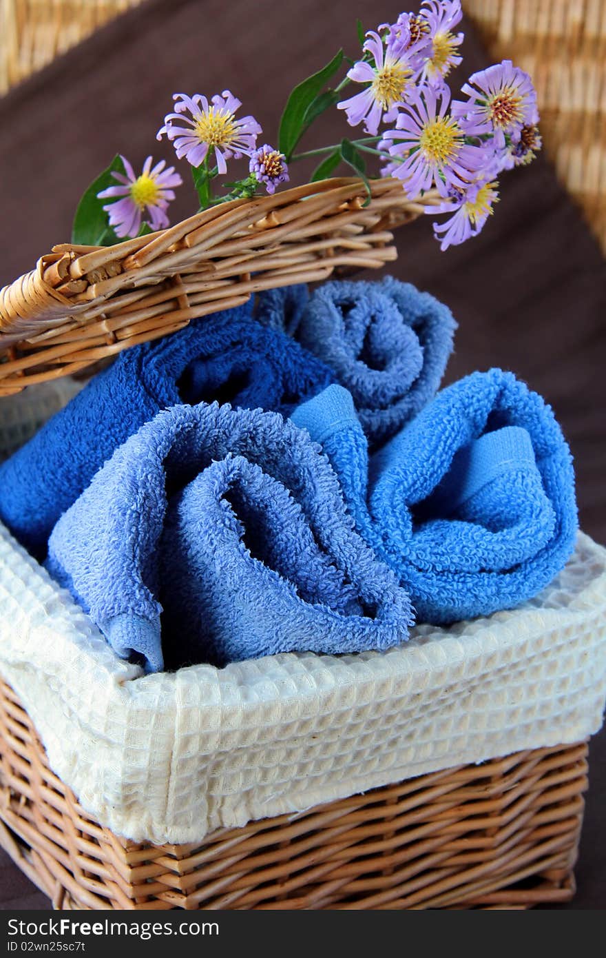 Pile of blue and blue-purple towel with flower