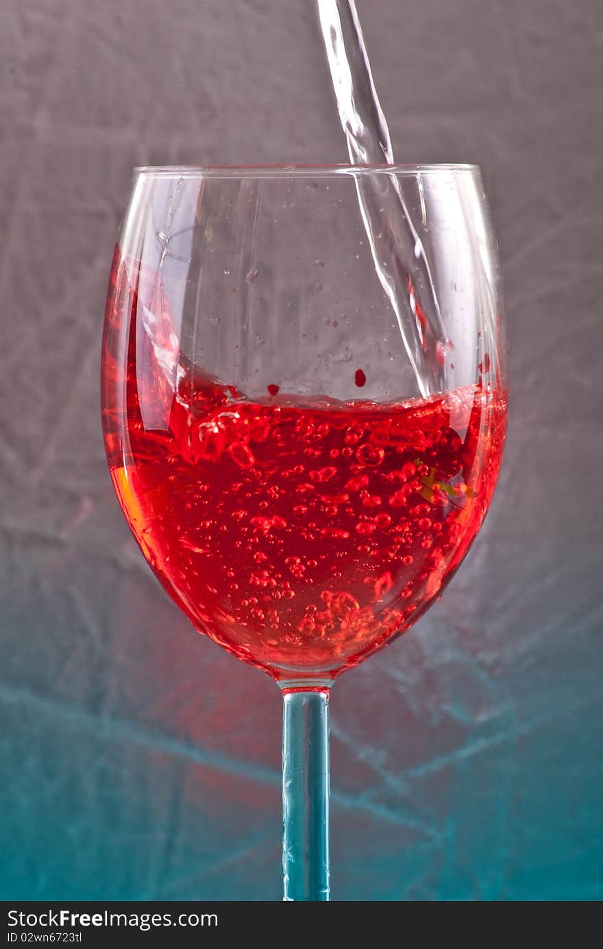 Clear Liquid Becoming Red in Wine Glass. Clear Liquid Becoming Red in Wine Glass