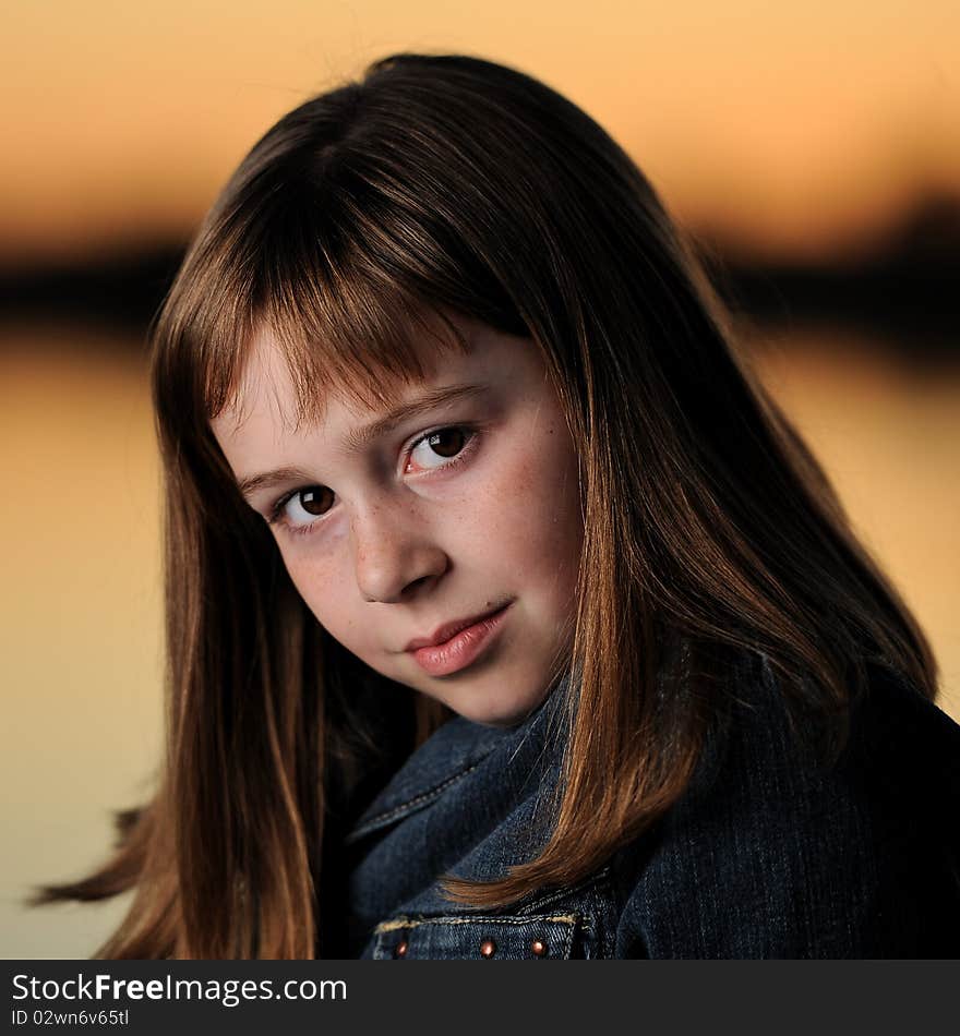 Young brunette caucasian girl with bangs at sunset. Young brunette caucasian girl with bangs at sunset