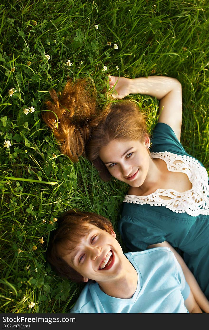 Happy young couple lying on grass. Happy young couple lying on grass