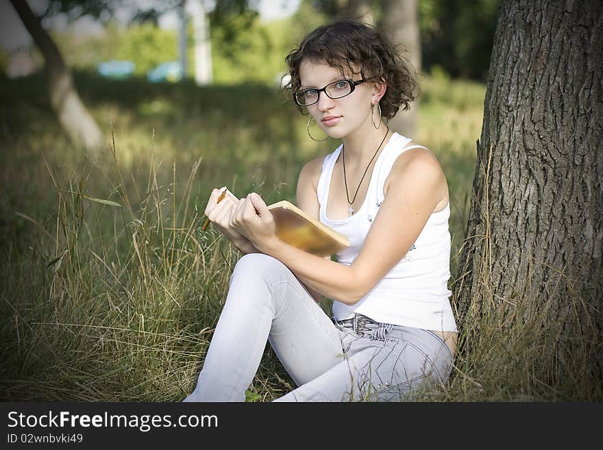 Girls reading book in park. Girls reading book in park