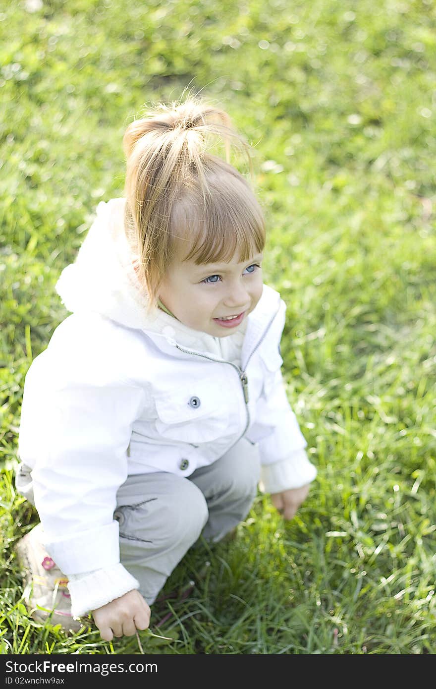 Little girl outdoors on grass