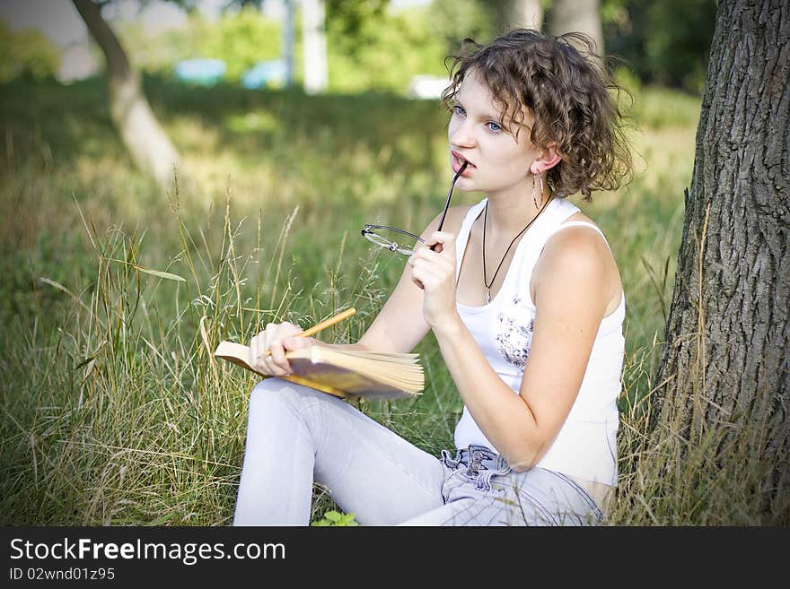 Girl reading book outdoors