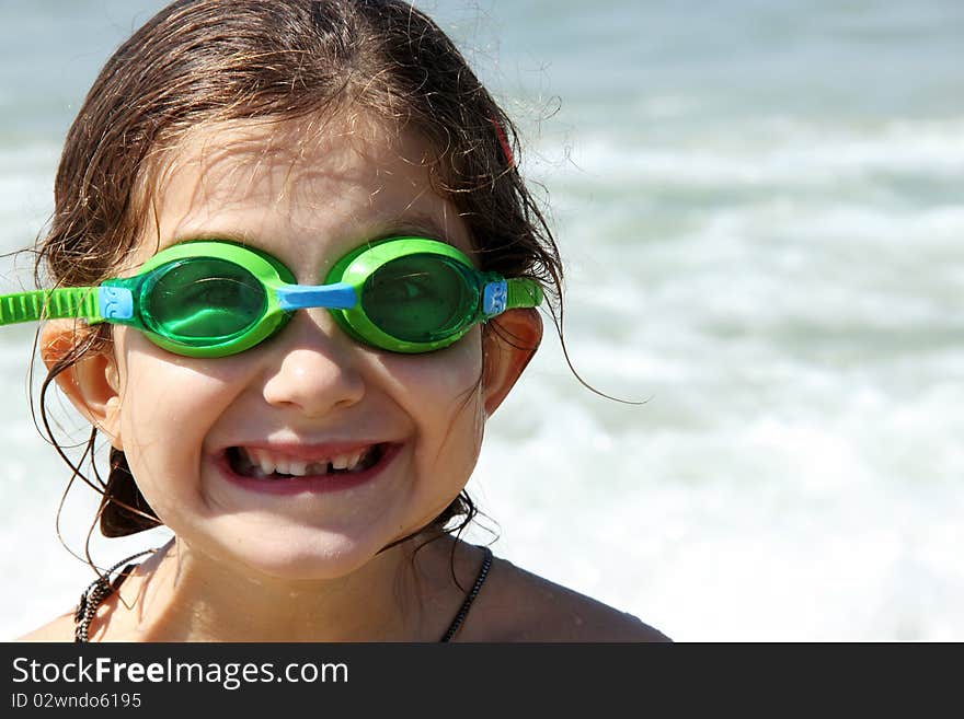 Beautiful, funny, girl seven years at sea. There is no front teeth. She is wearing glasses for swimming. Beautiful, funny, girl seven years at sea. There is no front teeth. She is wearing glasses for swimming