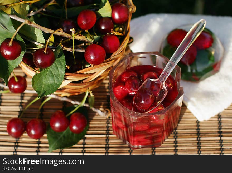 Bowl of cherry jam and some fresh fruits