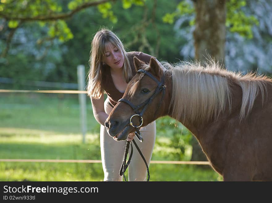 Woman bonding and being affectionate with shetland pony. Woman bonding and being affectionate with shetland pony