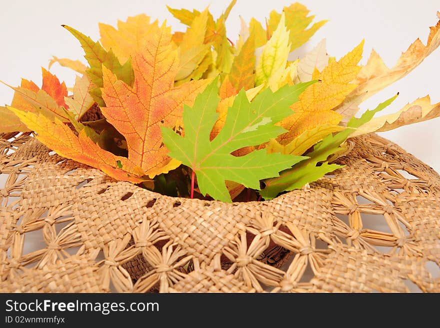 Straw hat with autumn leaves. Straw hat with autumn leaves