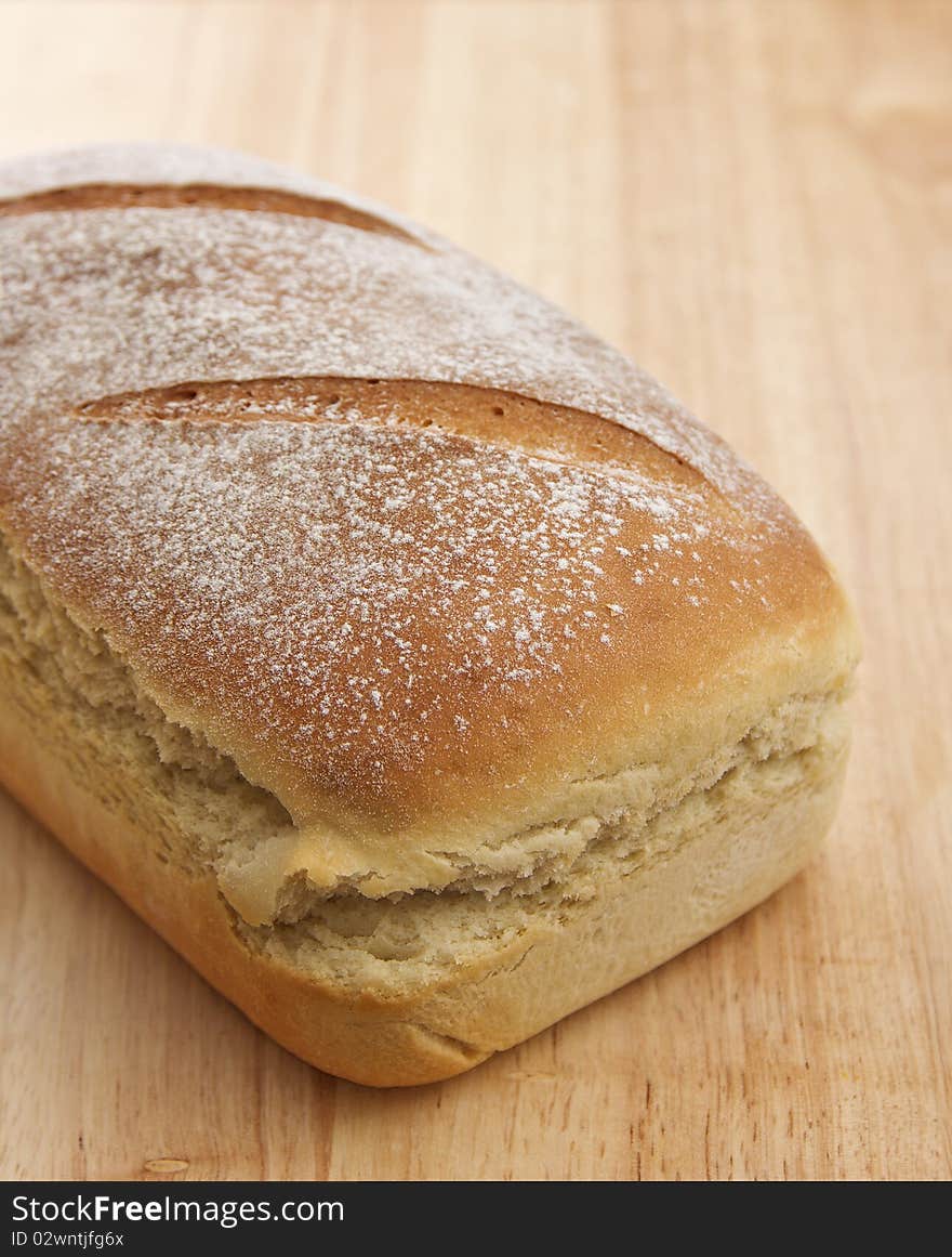 Home made loaf of bread on wooden surface