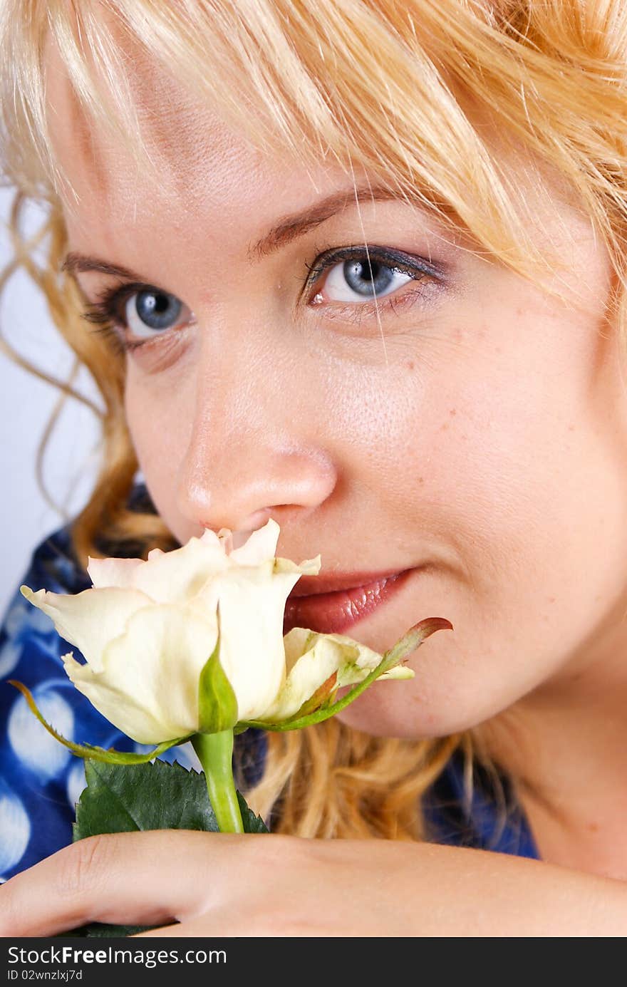 Blond holding a white rose.