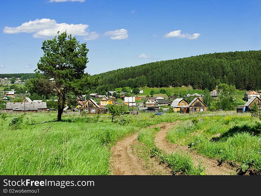 Summer landscape with a country road going to the Russian village. Summer landscape with a country road going to the Russian village