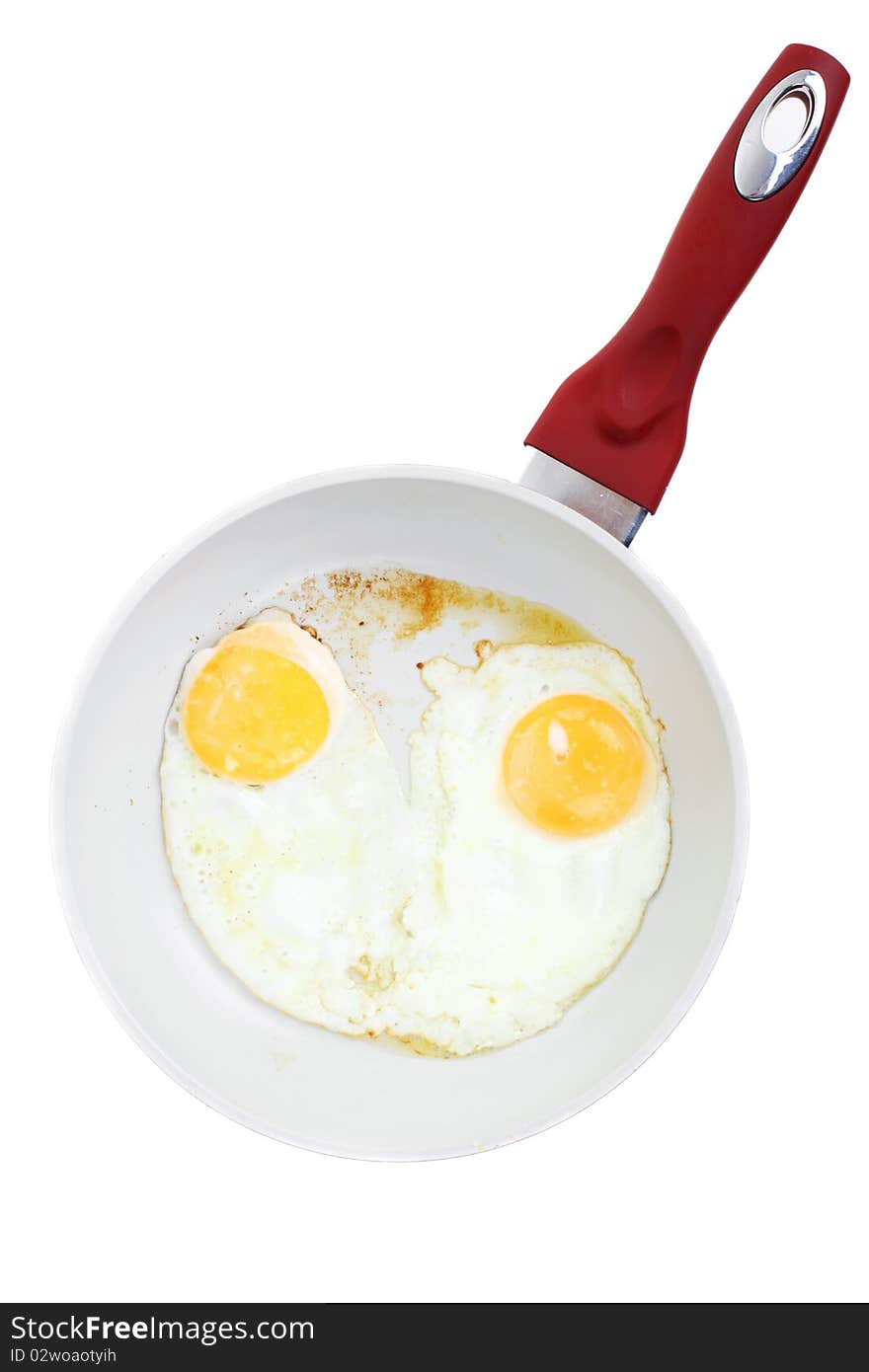 Broken Egg Frying In A Pan Isolated On White