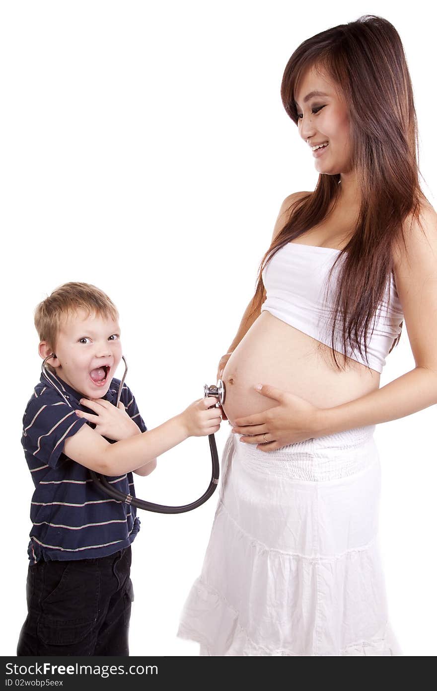 Boy excited and listening to moms belly