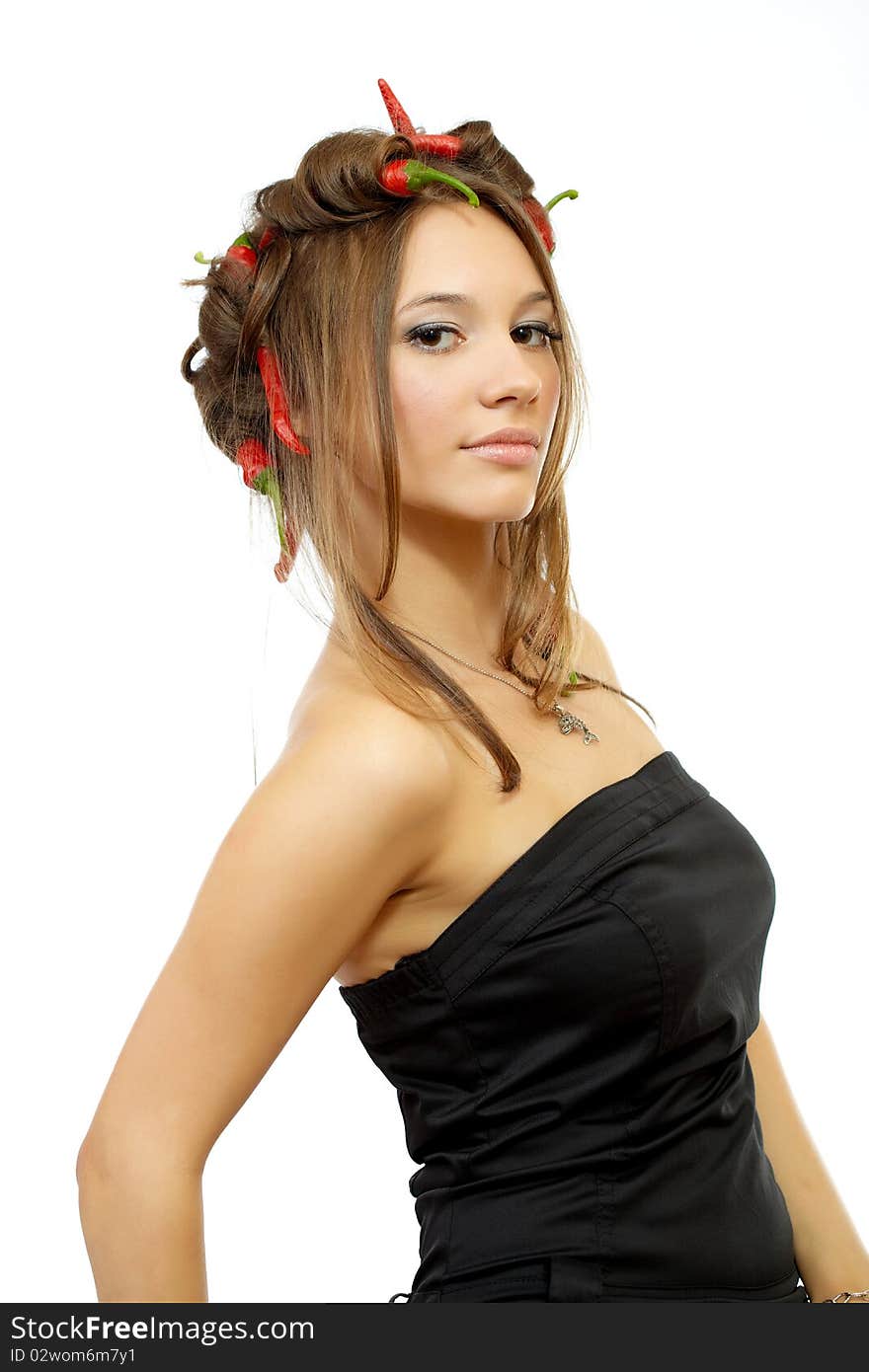 Portrait of a young woman with creative hair style with red hot chili peppers in her hair isolated on white. Portrait of a young woman with creative hair style with red hot chili peppers in her hair isolated on white