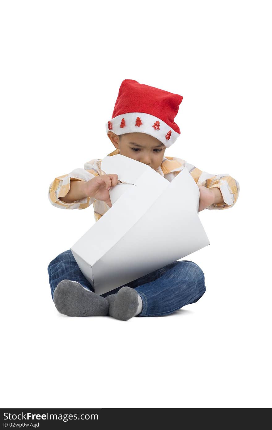 Cute boy with santa claus hat opening a gift, isolated on white background. Cute boy with santa claus hat opening a gift, isolated on white background