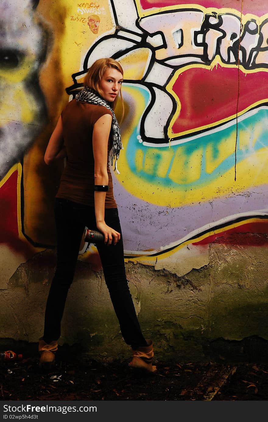 Model close to graffiti wall