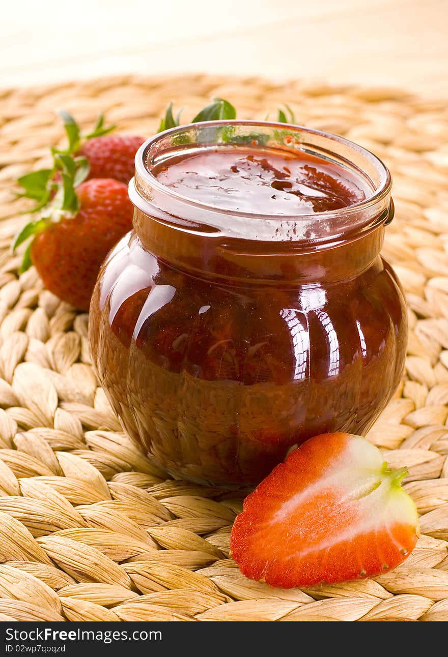 Red strawberries jam and glass jar. Red strawberries jam and glass jar