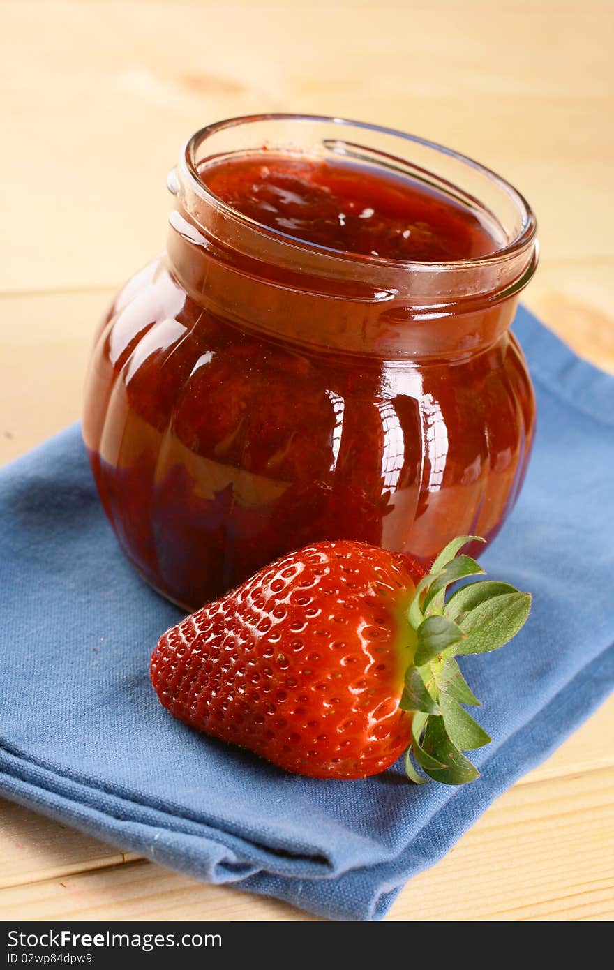 Red strawberries jam and glass jar. Red strawberries jam and glass jar