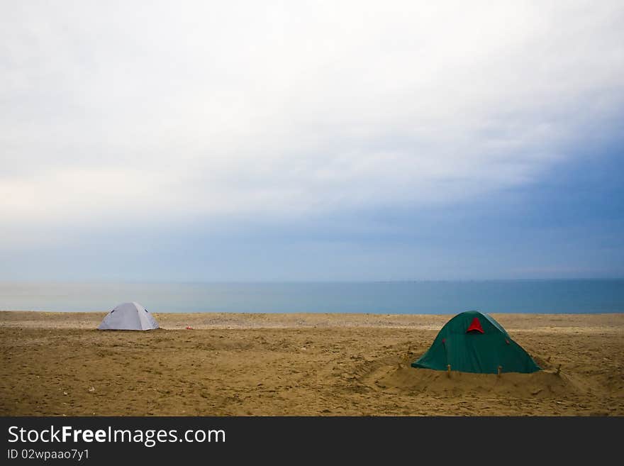 A beach scene with accumulated clouds and two tents. A beach scene with accumulated clouds and two tents