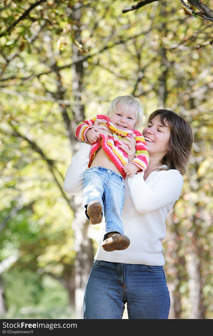 Mother and daughter playing in autumn park. Mother and daughter playing in autumn park