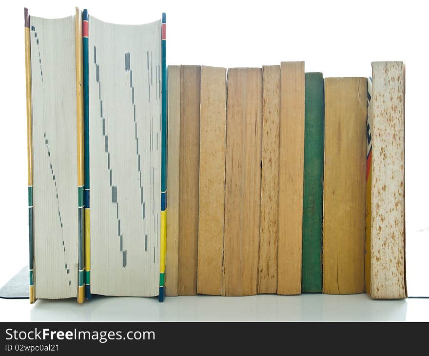 Stack of used books on white table and background