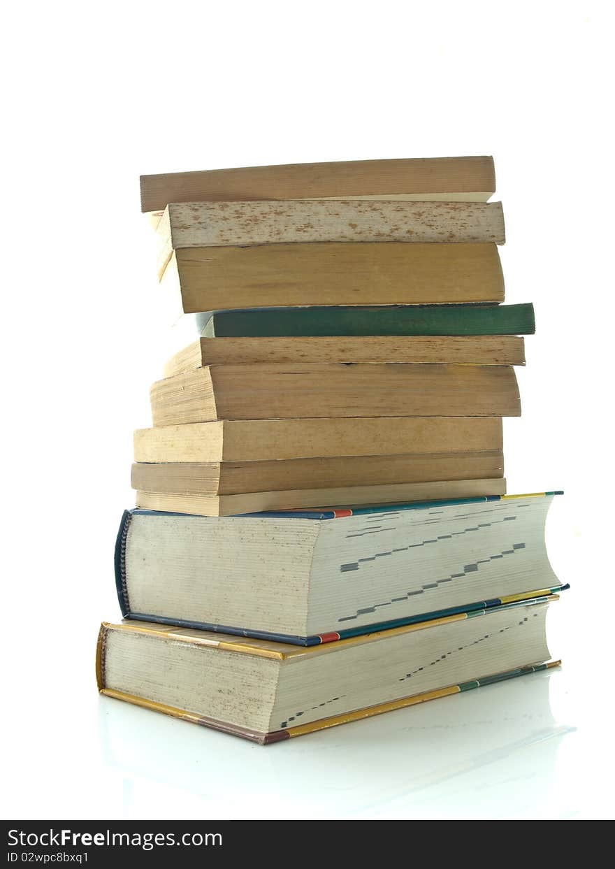 Stack of used books on white table and background