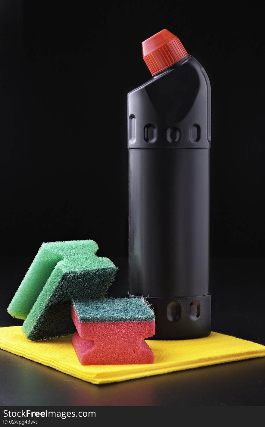 Detergent and sponge on a dark grey background