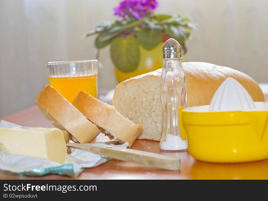 Two pieces of bread, butter and fruit juice for breakfast before the workday. Two pieces of bread, butter and fruit juice for breakfast before the workday