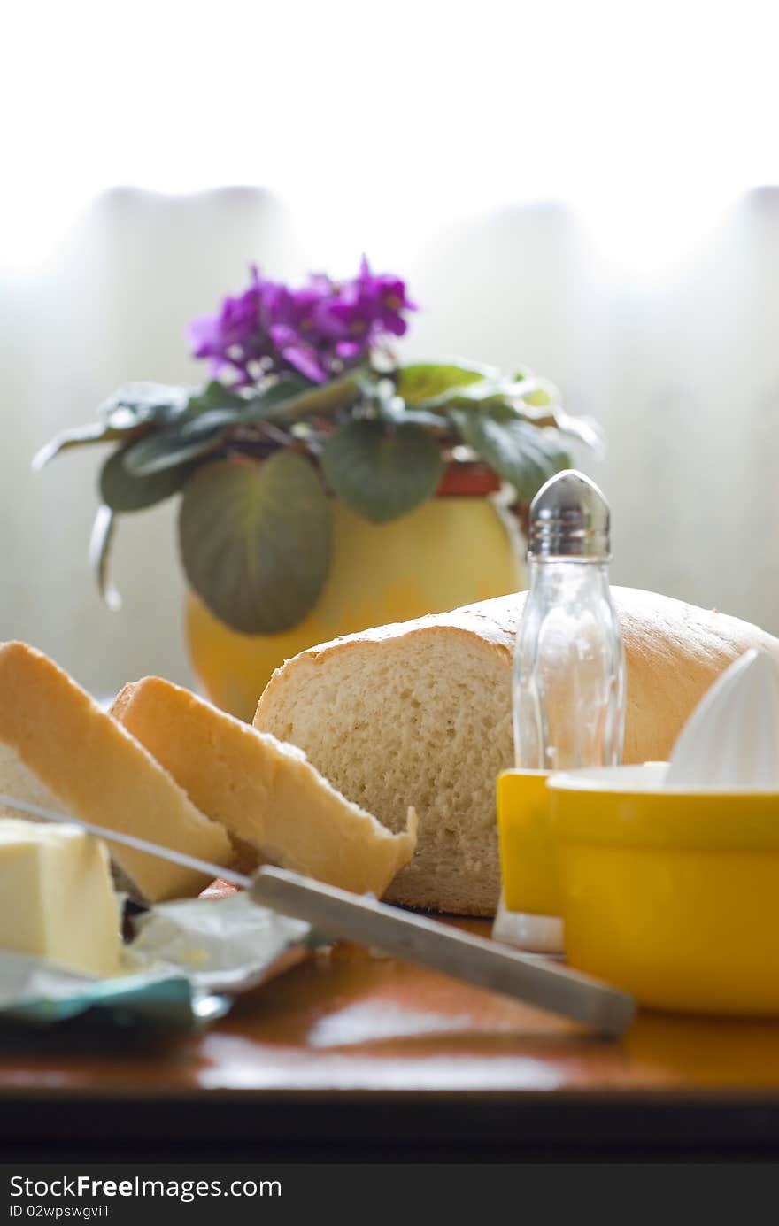 Two pieces of bread and butter for a light breakfast. Two pieces of bread and butter for a light breakfast