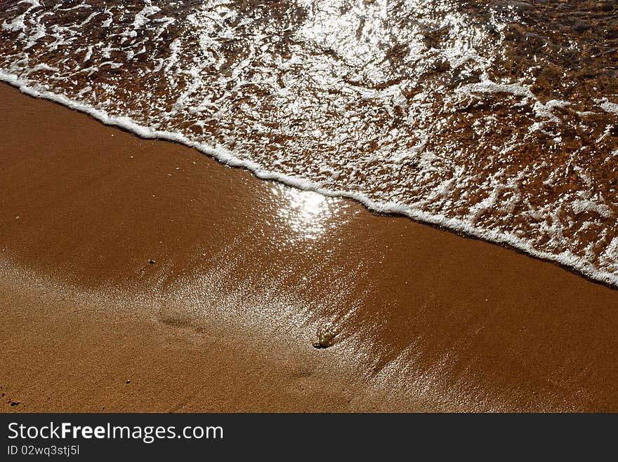 Reflection of the sun sand and water. Reflection of the sun sand and water