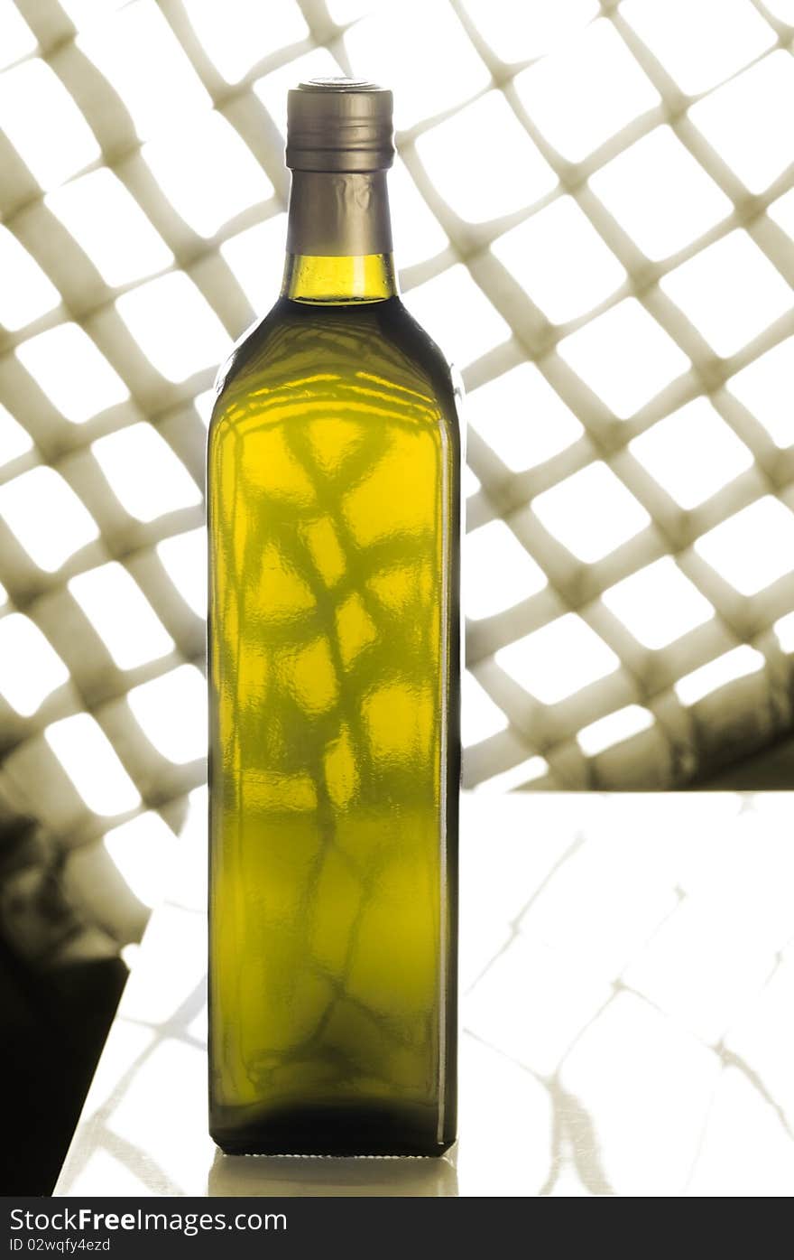 Olive oil bottle still-life over sepia background