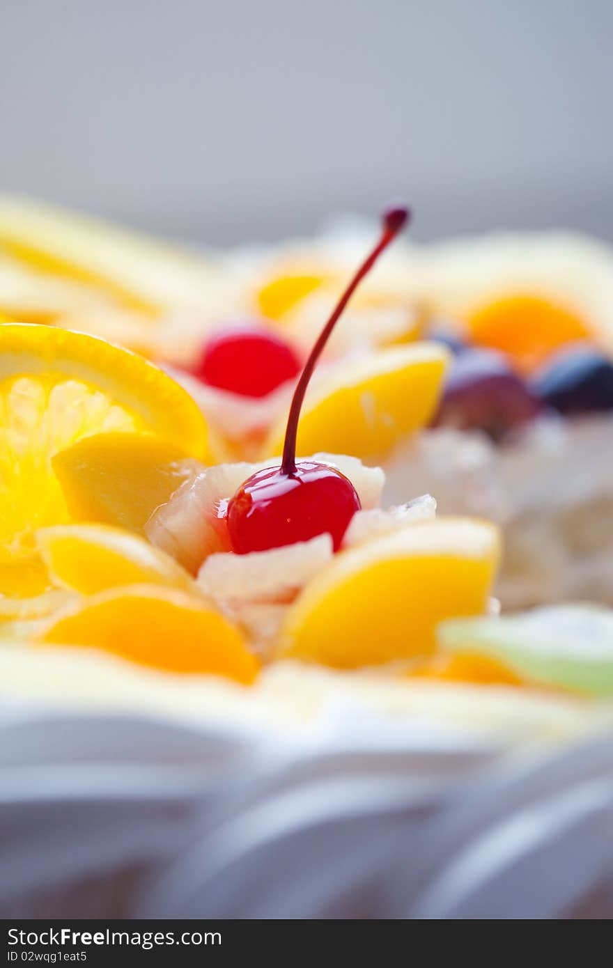 Pie Decorated With Fruit And A Cherry