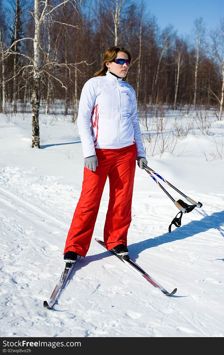 Girl on skis in the winter forest