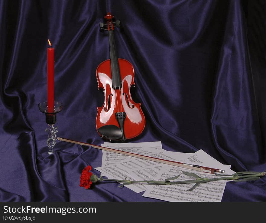 Violin notes of a candle and a flower on a blue background. Violin notes of a candle and a flower on a blue background