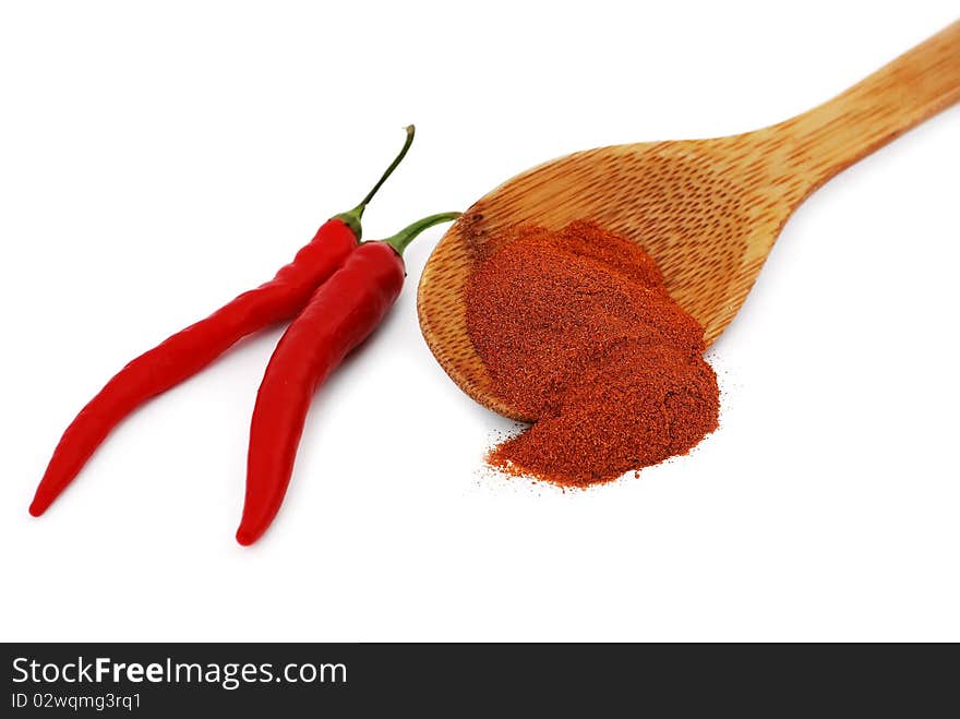 Ground pepper with a wooden spoon and pods. Ground pepper with a wooden spoon and pods