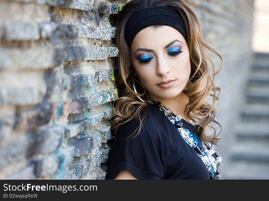 Beautiful woman near the wall