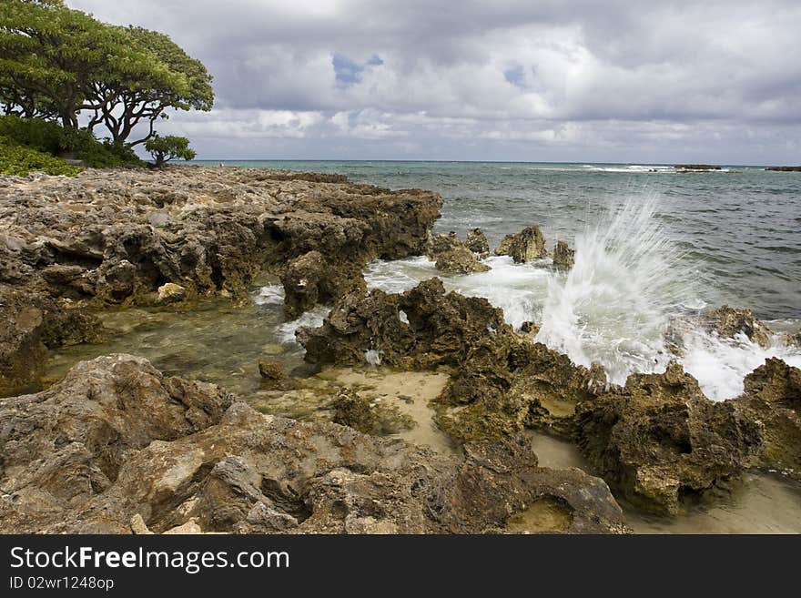 Wave crashing on rocks on the Island of Oahu in Hawaii. Wave crashing on rocks on the Island of Oahu in Hawaii